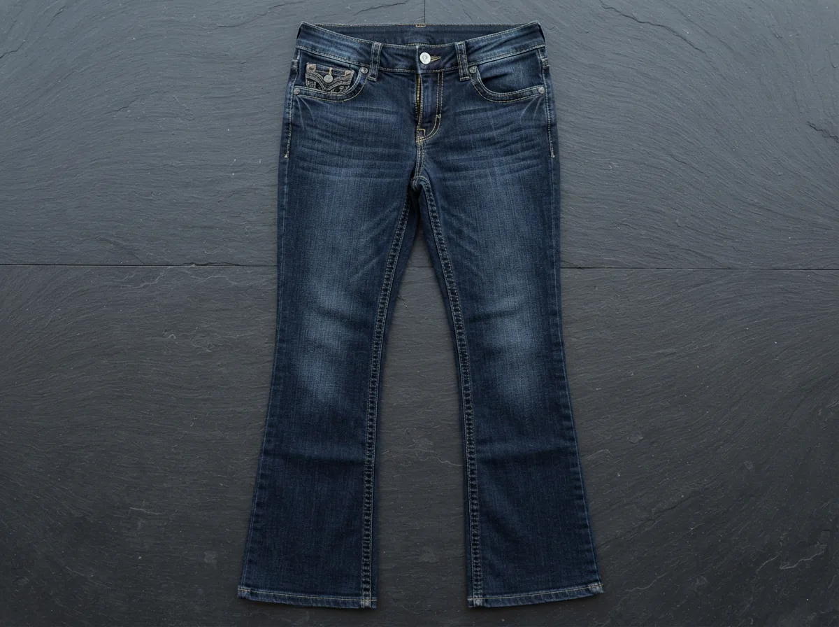 Front view of the Dereon Jeans NWOT Dark Wash Bootcut, displaying the signature embroidered flap pockets and mid-rise fit.